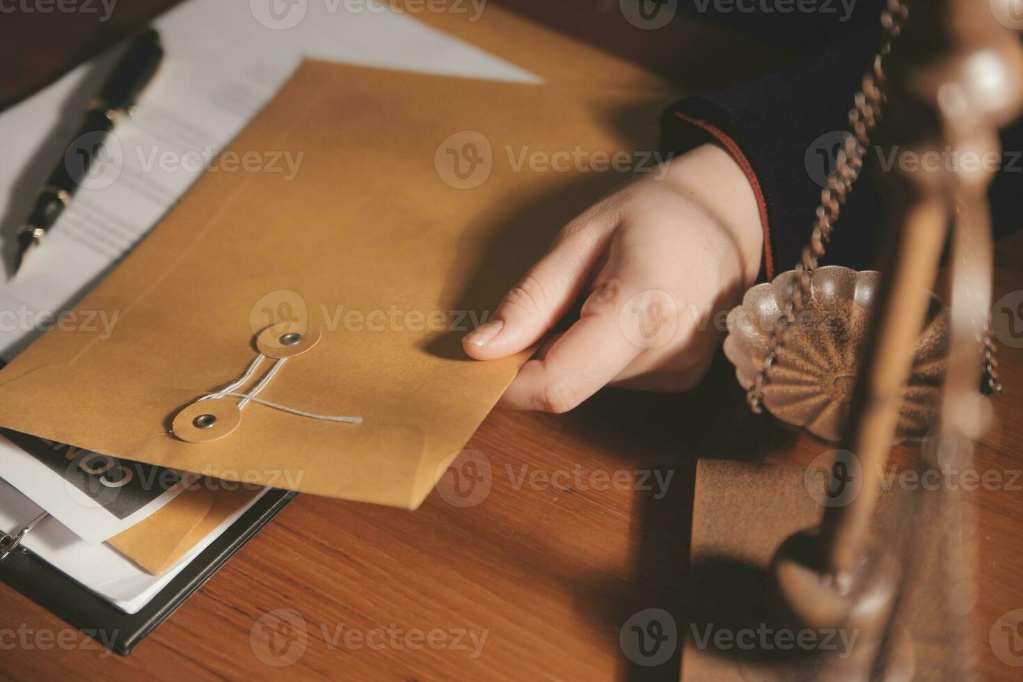 Business and lawyers discussing contract papers with brass scale on desk in office. Law, legal services, advice, justice and law concept picture with film grain effect photo