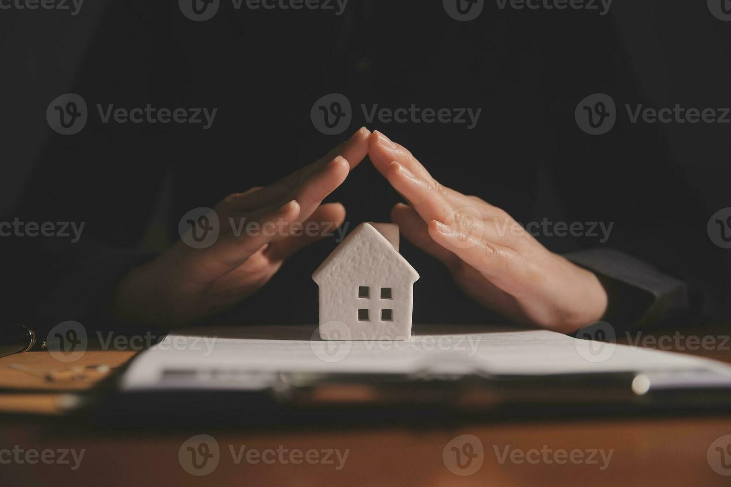 Real estate broker agent presenting and consult to customer to decision making sign insurance form agreement, buy and sell home model, concerning mortgage loan offer for and house insurance photo