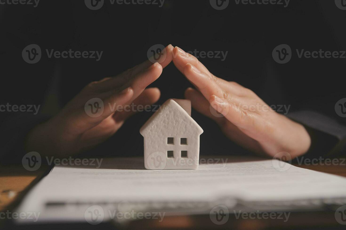 Real estate broker agent presenting and consult to customer to decision making sign insurance form agreement, buy and sell home model, concerning mortgage loan offer for and house insurance photo