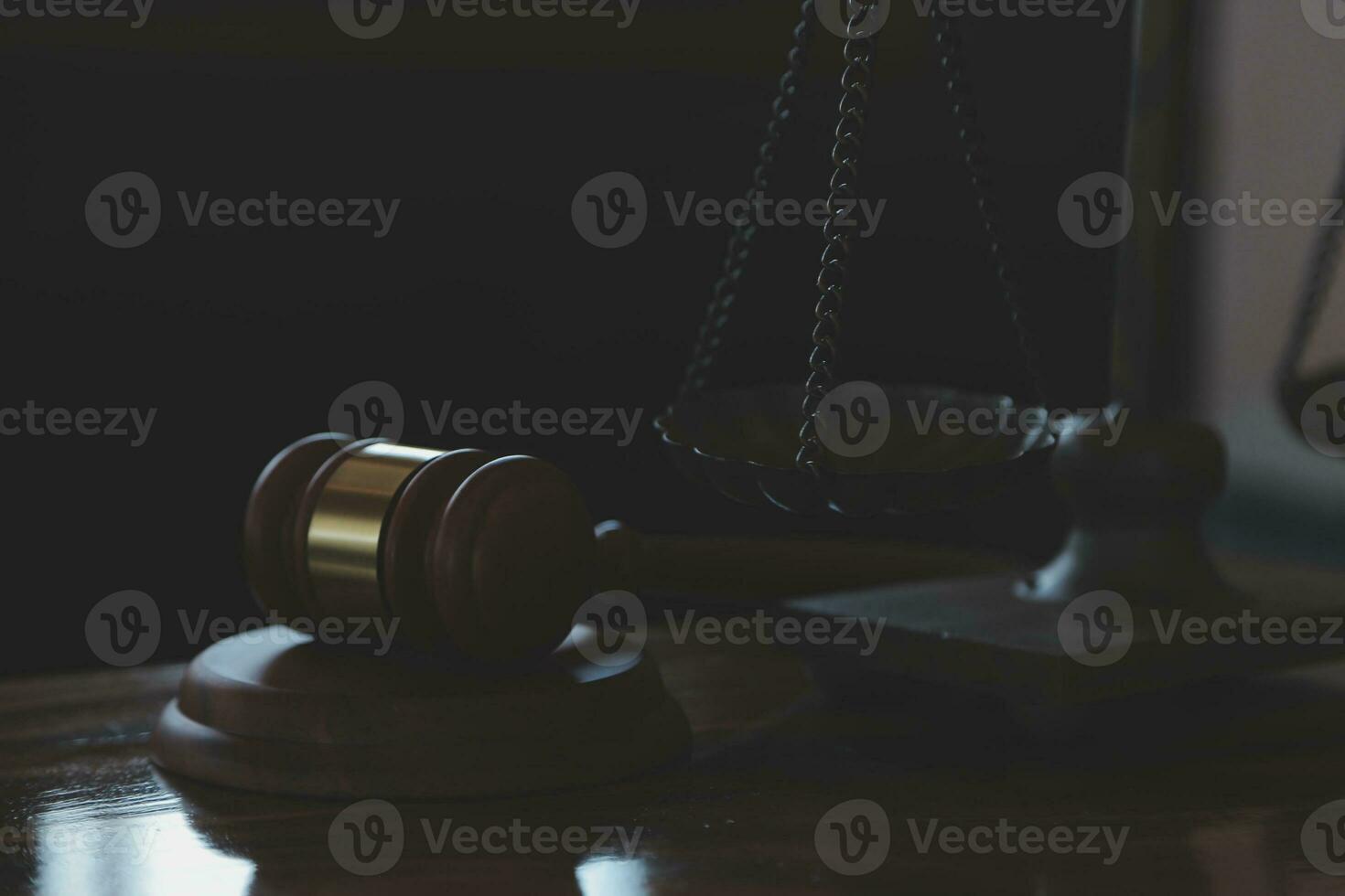 Justice and law concept.Male judge in a courtroom with the gavel, working with, computer and docking keyboard, eyeglasses, on table in morning light photo