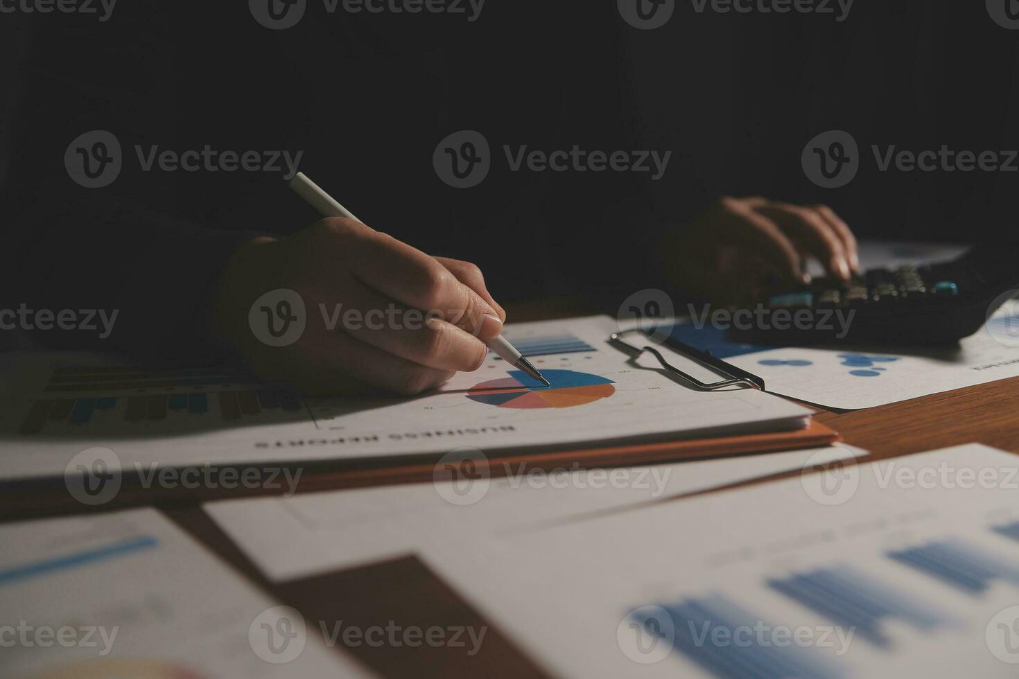Close up businessman hand using calculator and working with laptop calculate about finance accounting at coffeeshop outdor.finance accounting concept photo