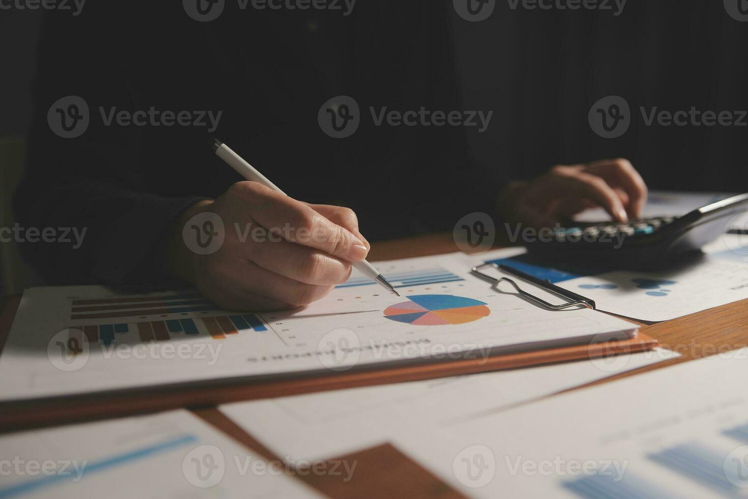 Close up businessman hand using calculator and working with laptop calculate about finance accounting at coffeeshop outdor.finance accounting concept photo