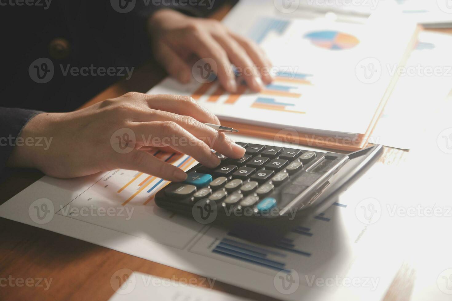 Close up businessman hand using calculator and working with laptop calculate about finance accounting at coffeeshop outdor.finance accounting concept photo