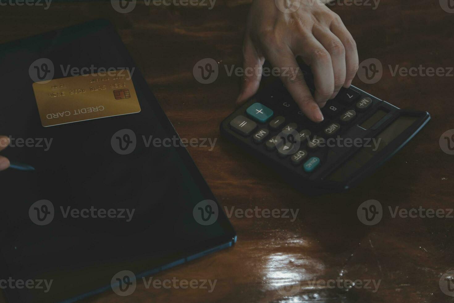 Close up businessman hand using calculator and working with laptop calculate about finance accounting at coffeeshop outdor.finance accounting concept photo