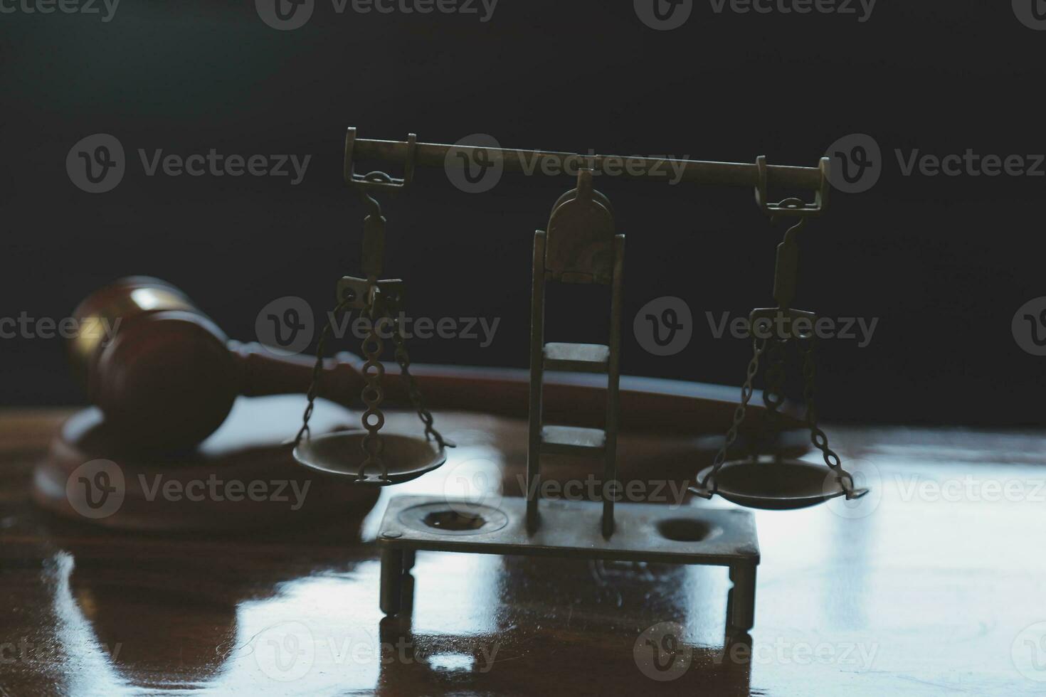 Justice and law concept.Male judge in a courtroom with the gavel, working with, computer and docking keyboard, eyeglasses, on table in morning light photo