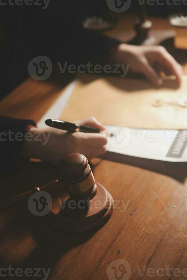 Business and lawyers discussing contract papers with brass scale on desk in office. Law, legal services, advice, justice and law concept picture with film grain effect photo