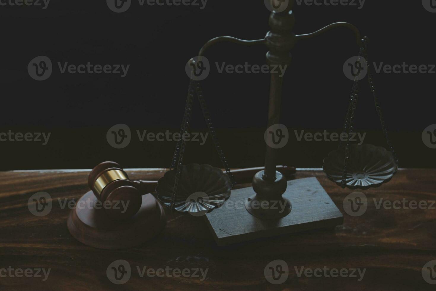 Justice and law concept.Male judge in a courtroom with the gavel, working with, computer and docking keyboard, eyeglasses, on table in morning light photo