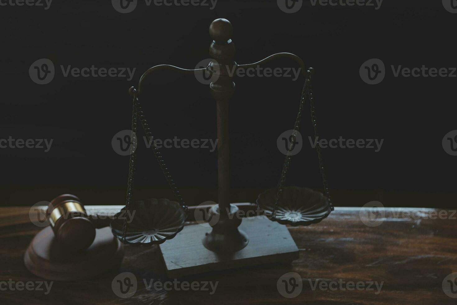 Justice and law concept.Male judge in a courtroom with the gavel, working with, computer and docking keyboard, eyeglasses, on table in morning light photo