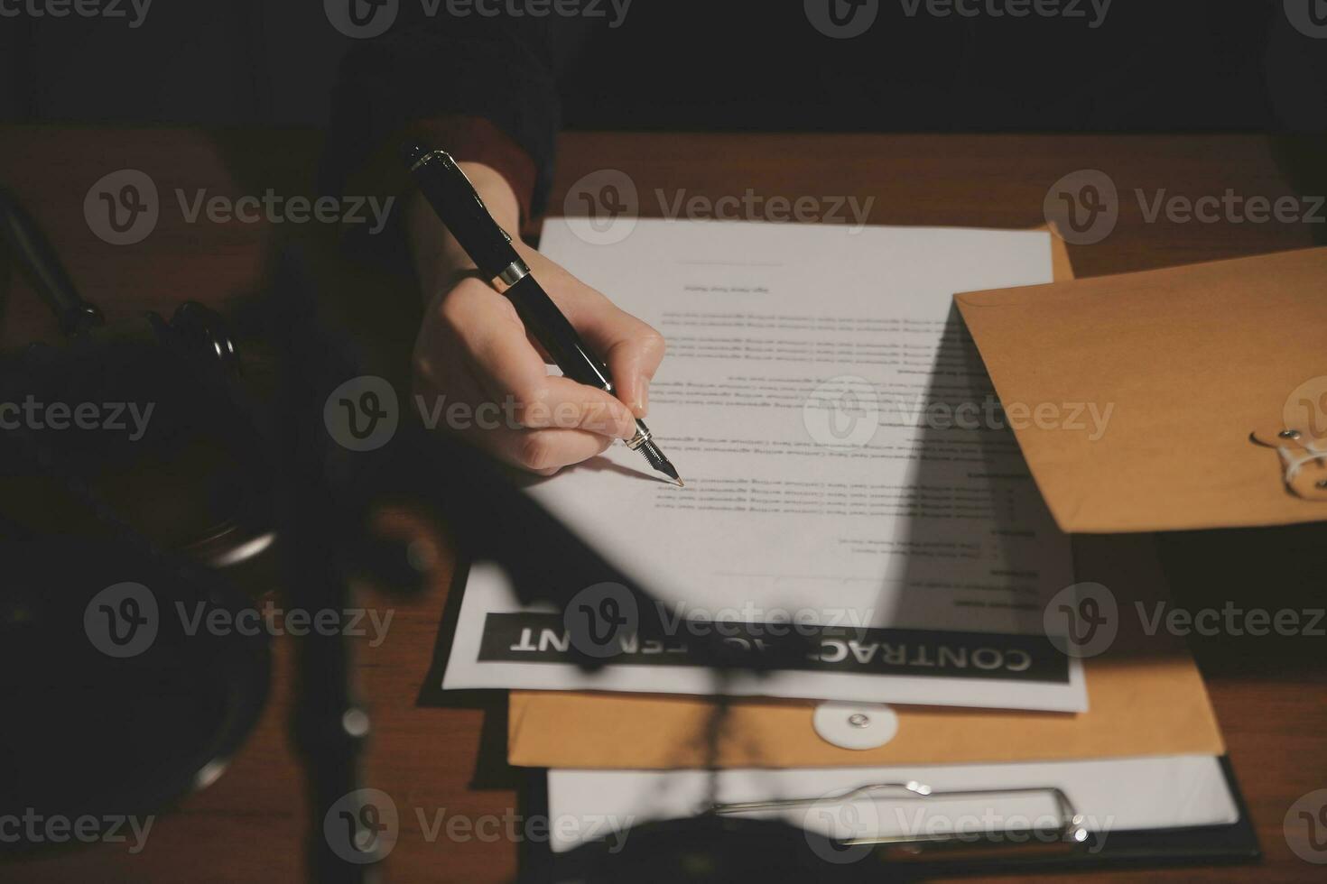 Business and lawyers discussing contract papers with brass scale on desk in office. Law, legal services, advice, justice and law concept picture with film grain effect photo