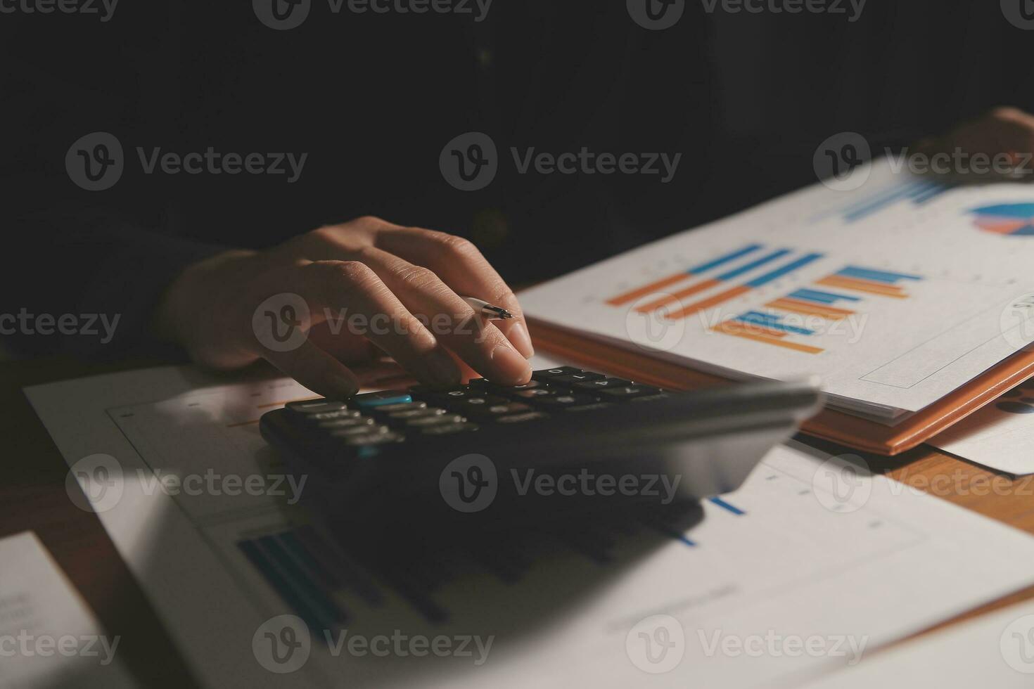 Close up businessman hand using calculator and working with laptop calculate about finance accounting at coffeeshop outdor.finance accounting concept photo