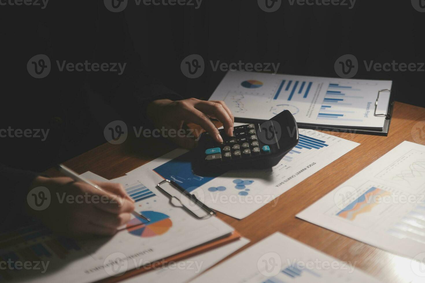 Close up businessman hand using calculator and working with laptop calculate about finance accounting at coffeeshop outdor.finance accounting concept photo