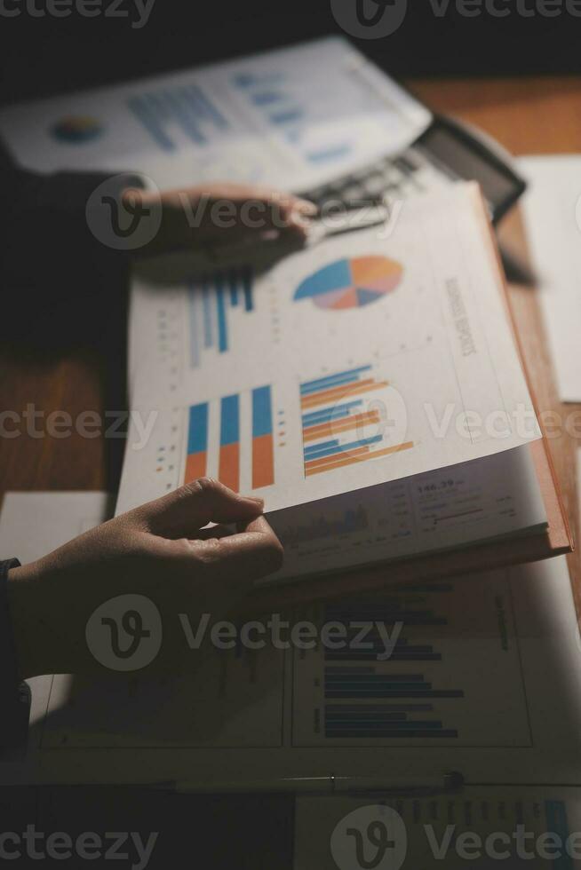 Close up businessman hand using calculator and working with laptop calculate about finance accounting at coffeeshop outdor.finance accounting concept photo