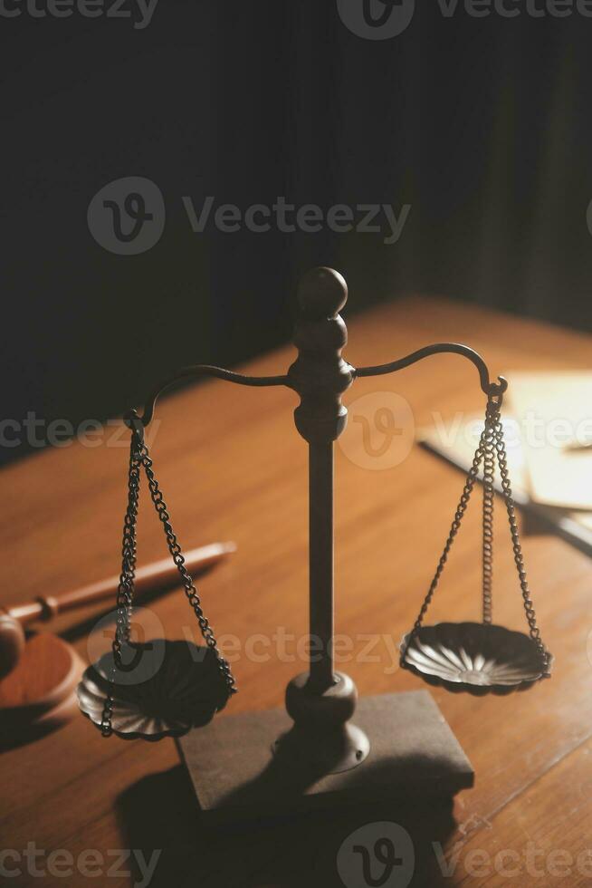 Business and lawyers discussing contract papers with brass scale on desk in office. Law, legal services, advice, justice and law concept picture with film grain effect photo
