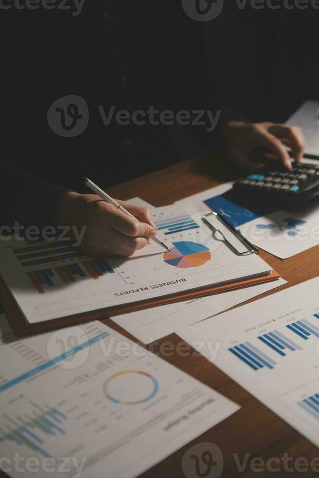 Close up businessman hand using calculator and working with laptop calculate about finance accounting at coffeeshop outdor.finance accounting concept photo