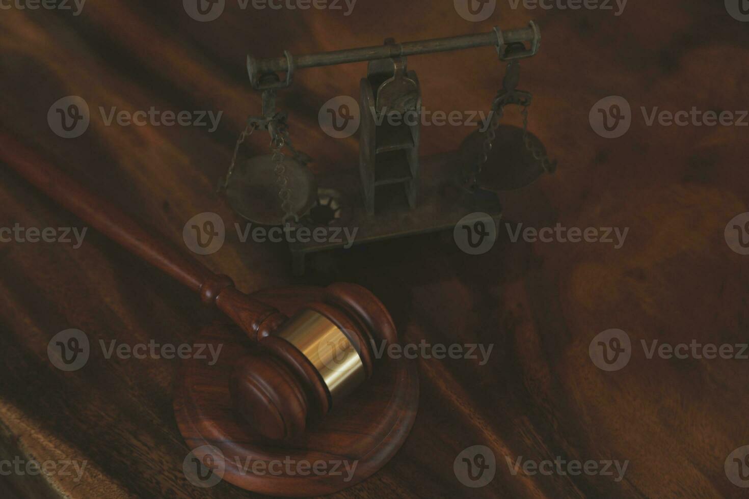 Justice and law concept.Male judge in a courtroom with the gavel, working with, computer and docking keyboard, eyeglasses, on table in morning light photo