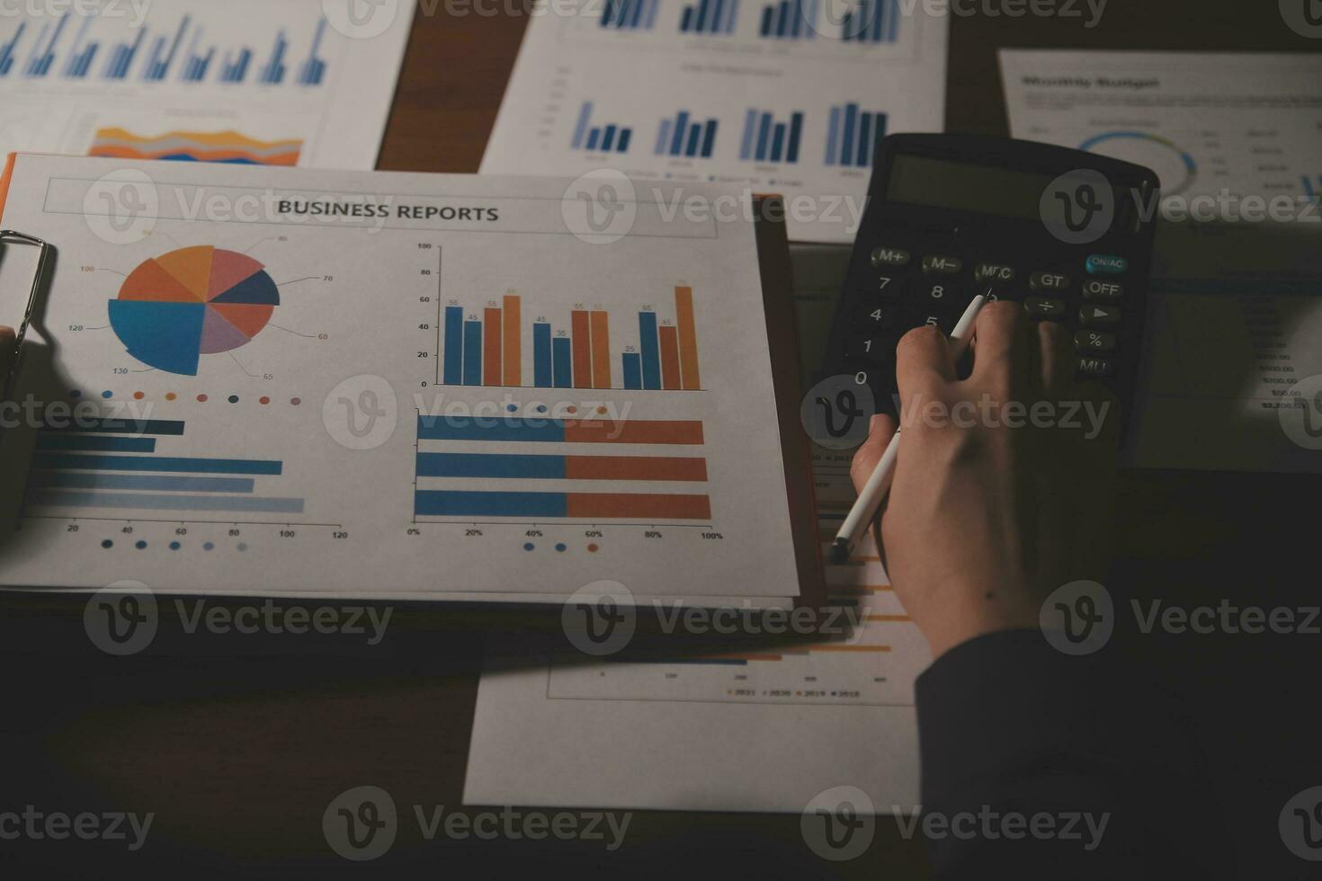 Close up businessman hand using calculator and working with laptop calculate about finance accounting at coffeeshop outdor.finance accounting concept photo