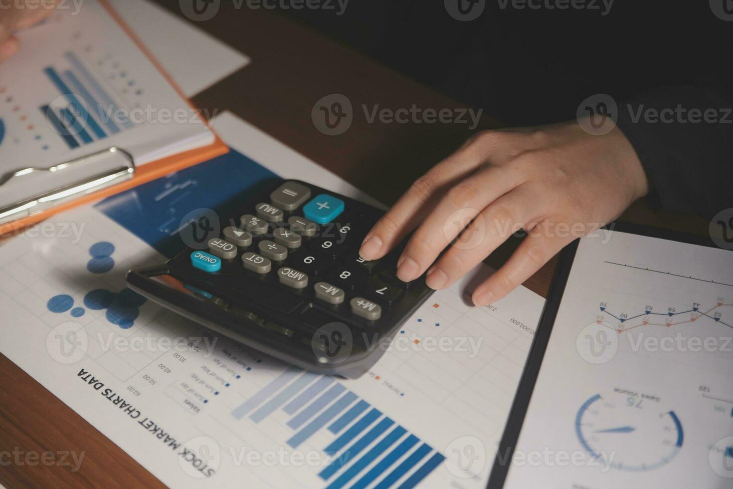 Close up businessman hand using calculator and working with laptop calculate about finance accounting at coffeeshop outdor.finance accounting concept photo