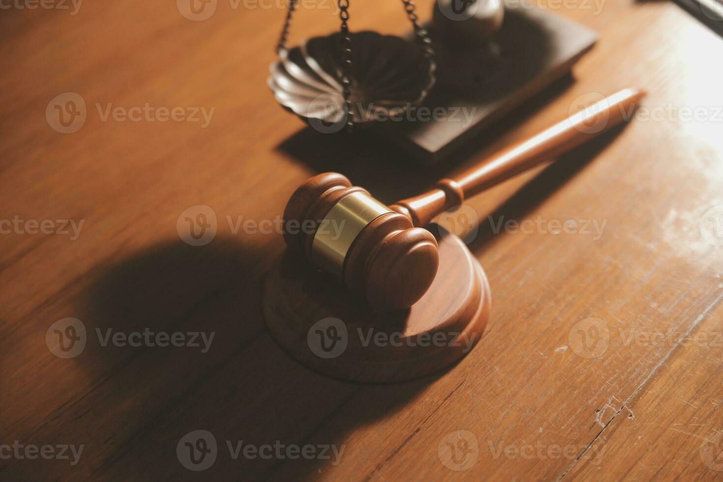 Business and lawyers discussing contract papers with brass scale on desk in office. Law, legal services, advice, justice and law concept picture with film grain effect photo
