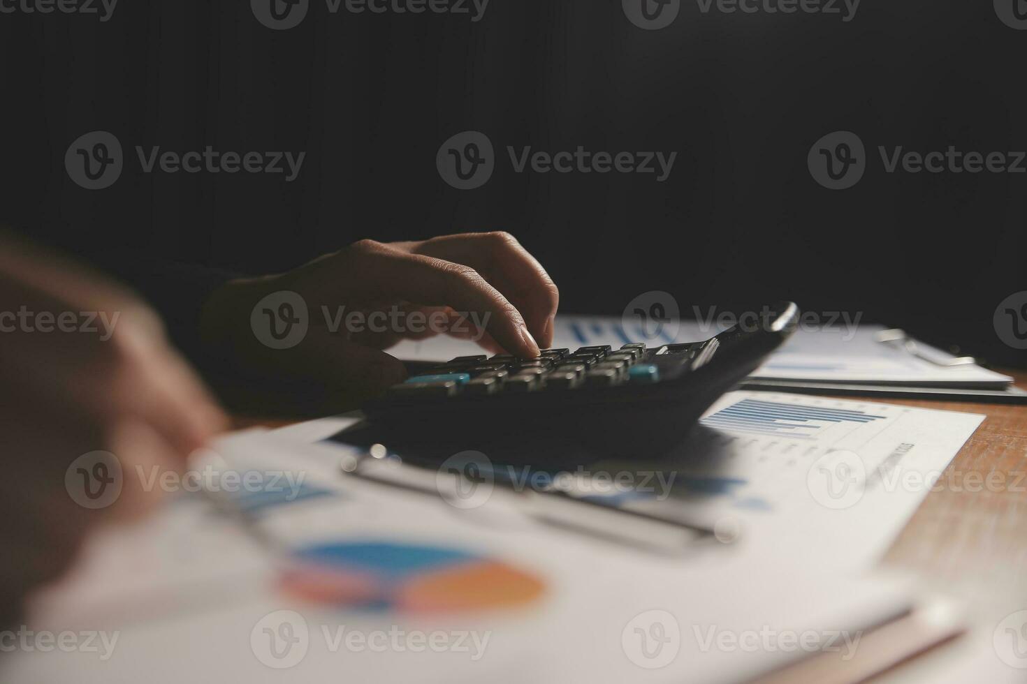 Close up businessman hand using calculator and working with laptop calculate about finance accounting at coffeeshop outdor.finance accounting concept photo
