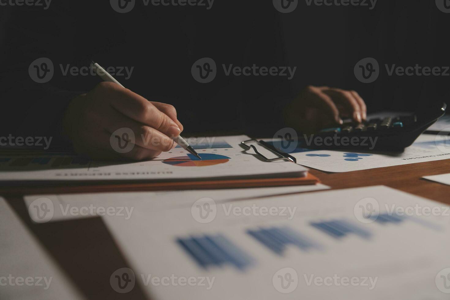 Close up businessman hand using calculator and working with laptop calculate about finance accounting at coffeeshop outdor.finance accounting concept photo