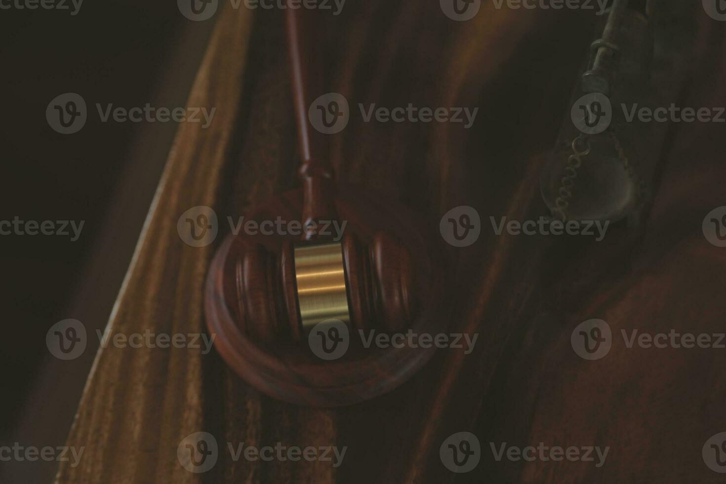 Justice and law concept.Male judge in a courtroom with the gavel, working with, computer and docking keyboard, eyeglasses, on table in morning light photo