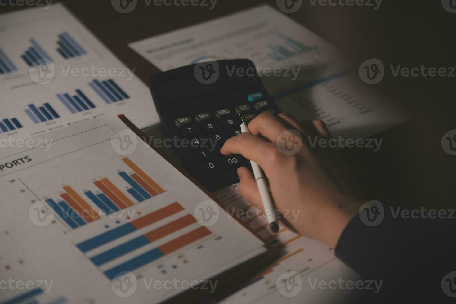 Close up businessman hand using calculator and working with laptop calculate about finance accounting at coffeeshop outdor.finance accounting concept photo