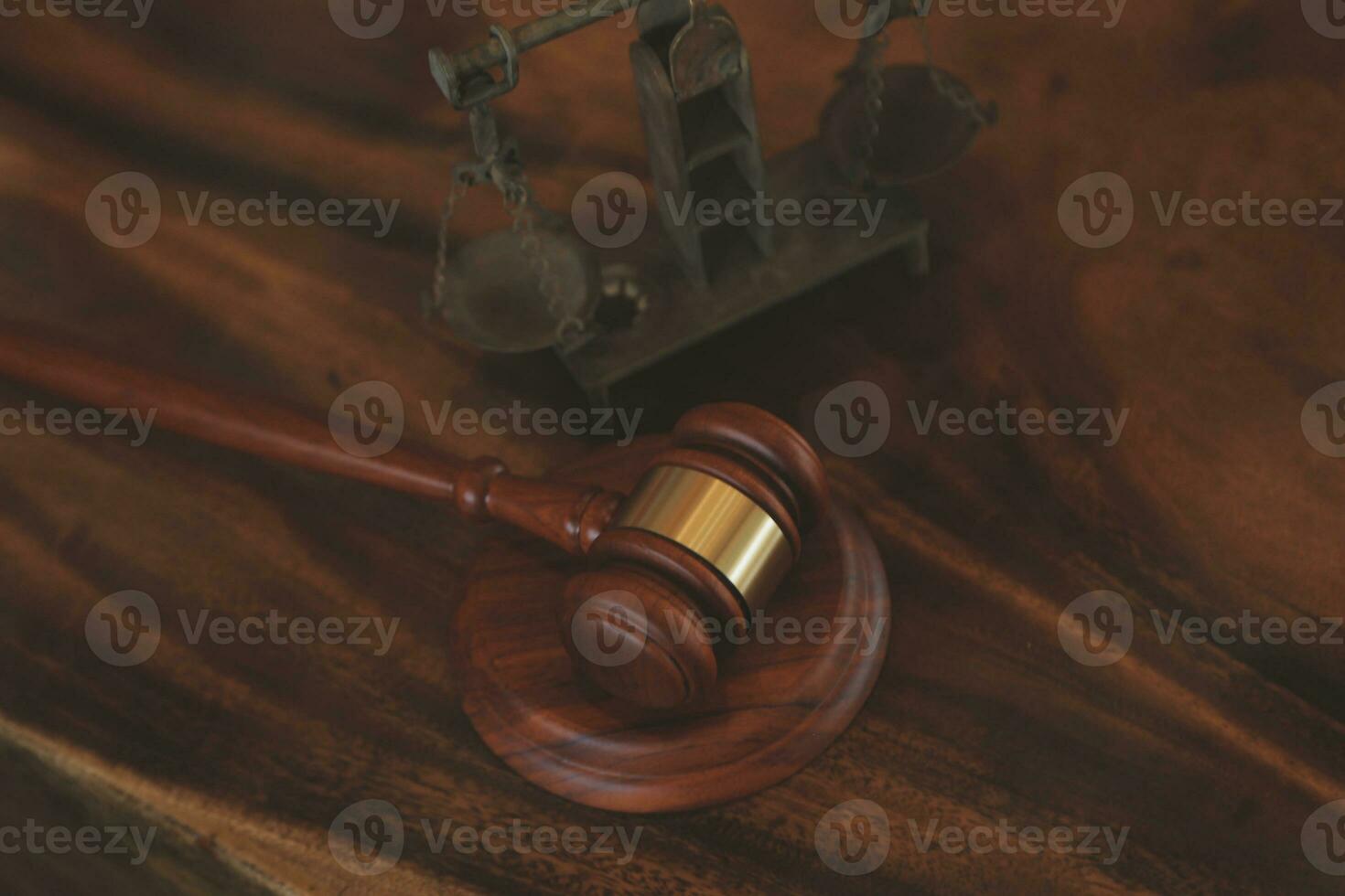 Justice and law concept.Male judge in a courtroom with the gavel, working with, computer and docking keyboard, eyeglasses, on table in morning light photo