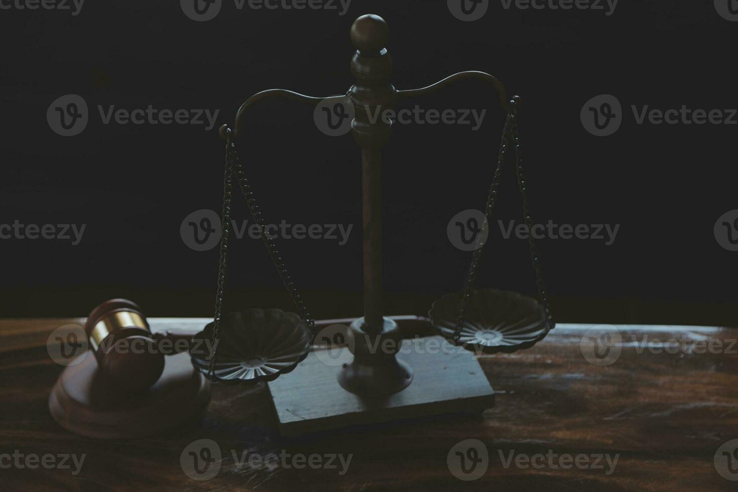 Justice and law concept.Male judge in a courtroom with the gavel, working with, computer and docking keyboard, eyeglasses, on table in morning light photo