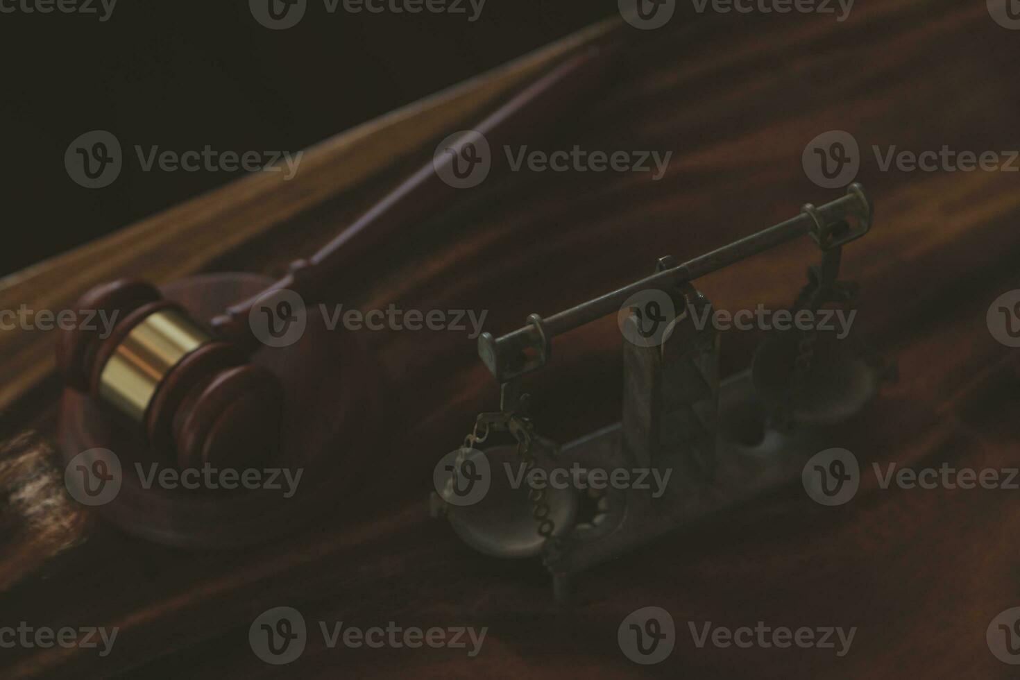 Justice and law concept.Male judge in a courtroom with the gavel, working with, computer and docking keyboard, eyeglasses, on table in morning light photo