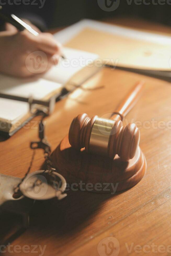 Business and lawyers discussing contract papers with brass scale on desk in office. Law, legal services, advice, justice and law concept picture with film grain effect photo