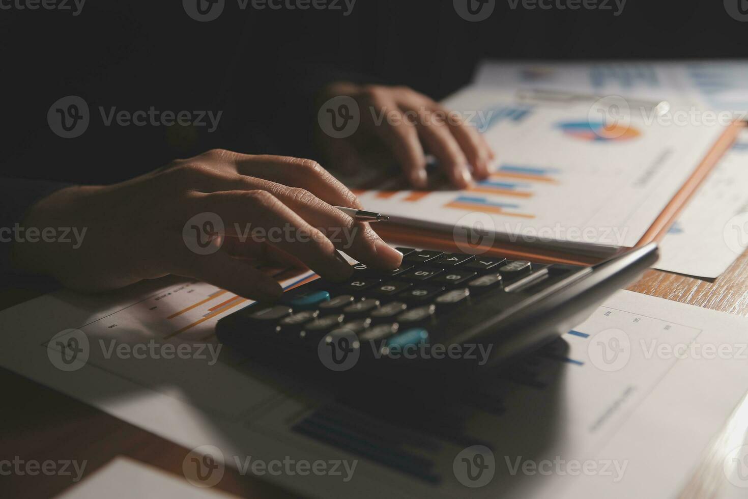 Close up businessman hand using calculator and working with laptop calculate about finance accounting at coffeeshop outdor.finance accounting concept photo