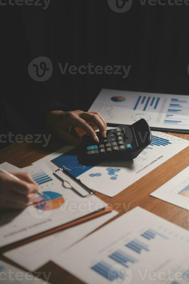 Close up businessman hand using calculator and working with laptop calculate about finance accounting at coffeeshop outdor.finance accounting concept photo
