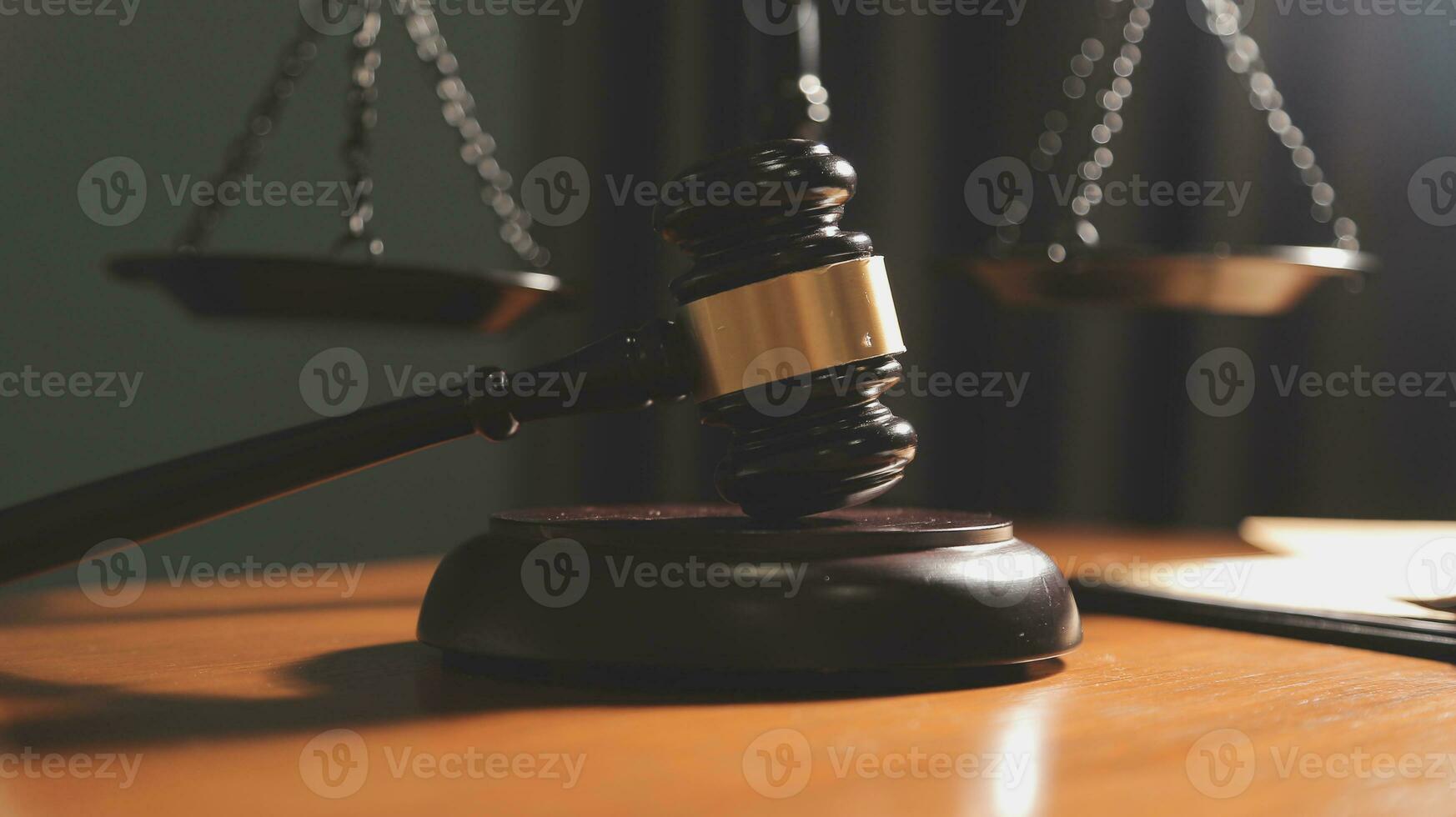 Business and lawyers discussing contract papers with brass scale on desk in office. Law, legal services, advice, justice and law concept picture with film grain effect photo