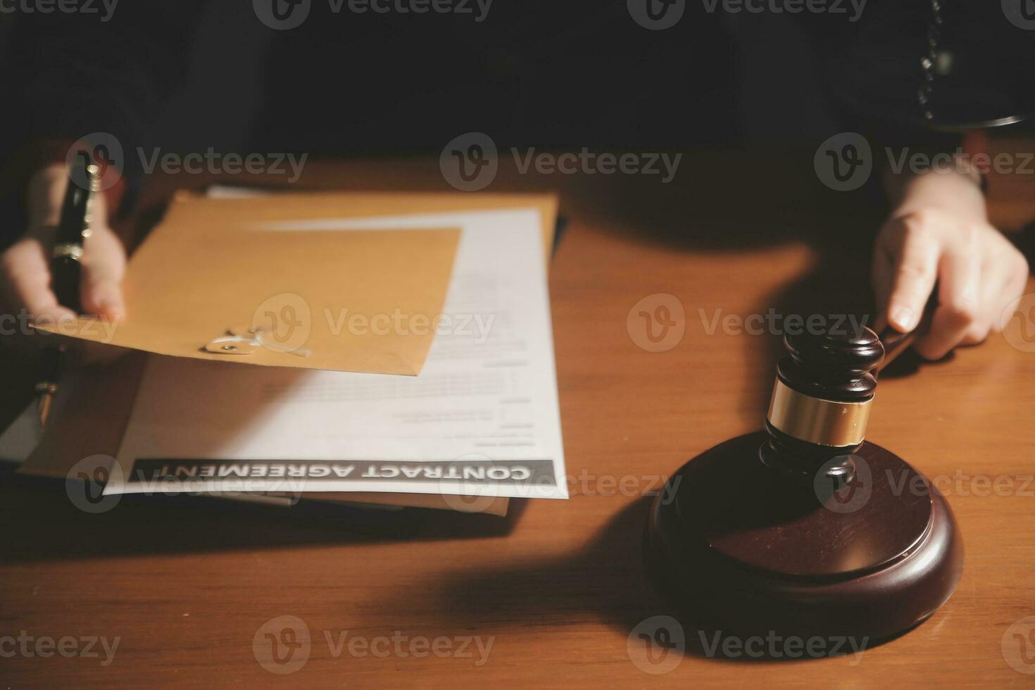 Business and lawyers discussing contract papers with brass scale on desk in office. Law, legal services, advice, justice and law concept picture with film grain effect photo