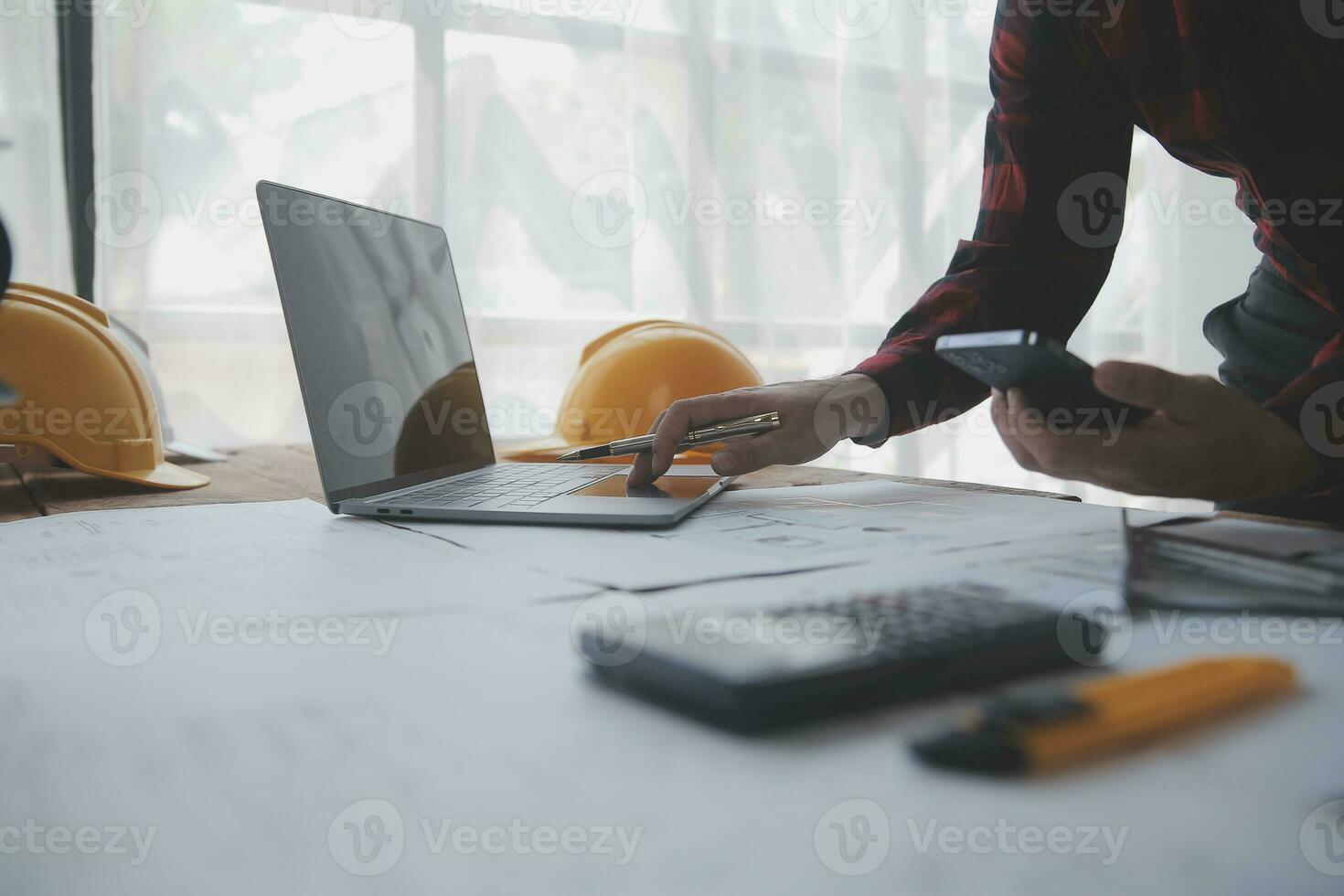 Construction and structure concept of engineer working drawing on blueprint meeting for project working with partner on model building and engineering tools in working site, construction concept. photo