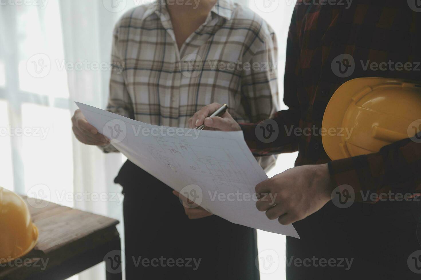 Construction and structure concept of engineer working drawing on blueprint meeting for project working with partner on model building and engineering tools in working site, construction concept. photo