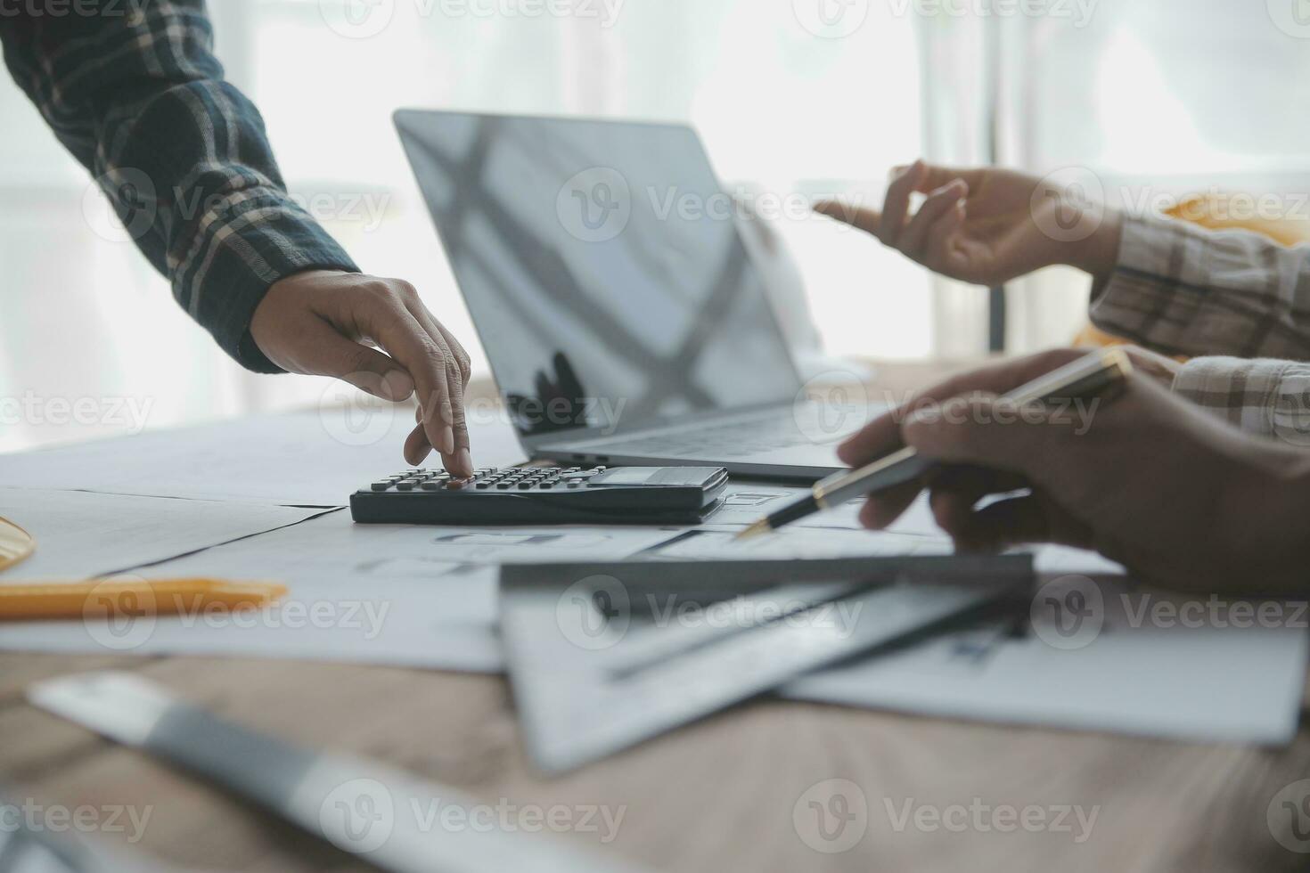 Construction and structure concept of engineer working drawing on blueprint meeting for project working with partner on model building and engineering tools in working site, construction concept. photo