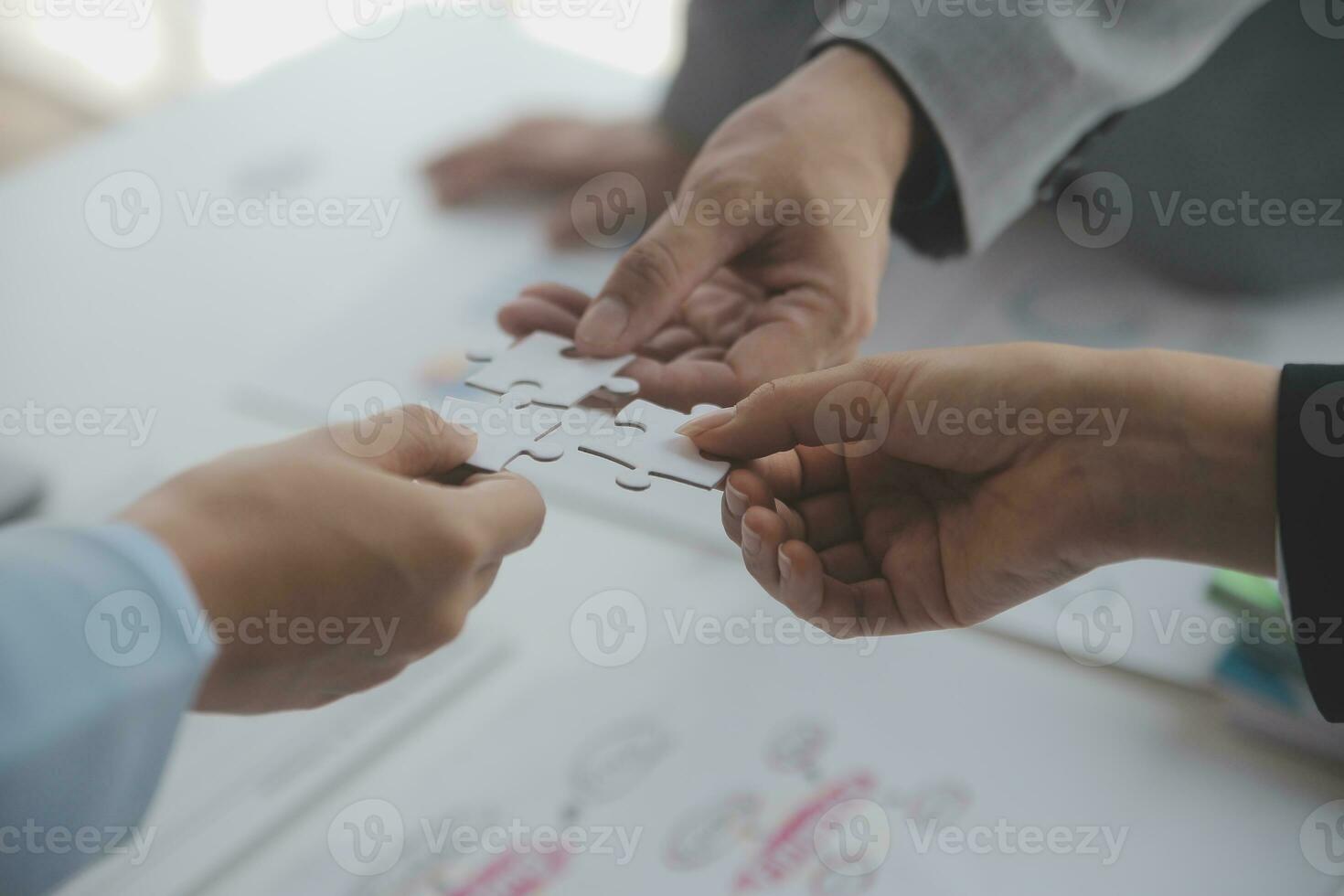Cropped shot of Businesswoman hand connecting jigsaw puzzle with sunlight effect, Business solutions, success, and Assembling jigsaw pieces, strategy ideas. photo