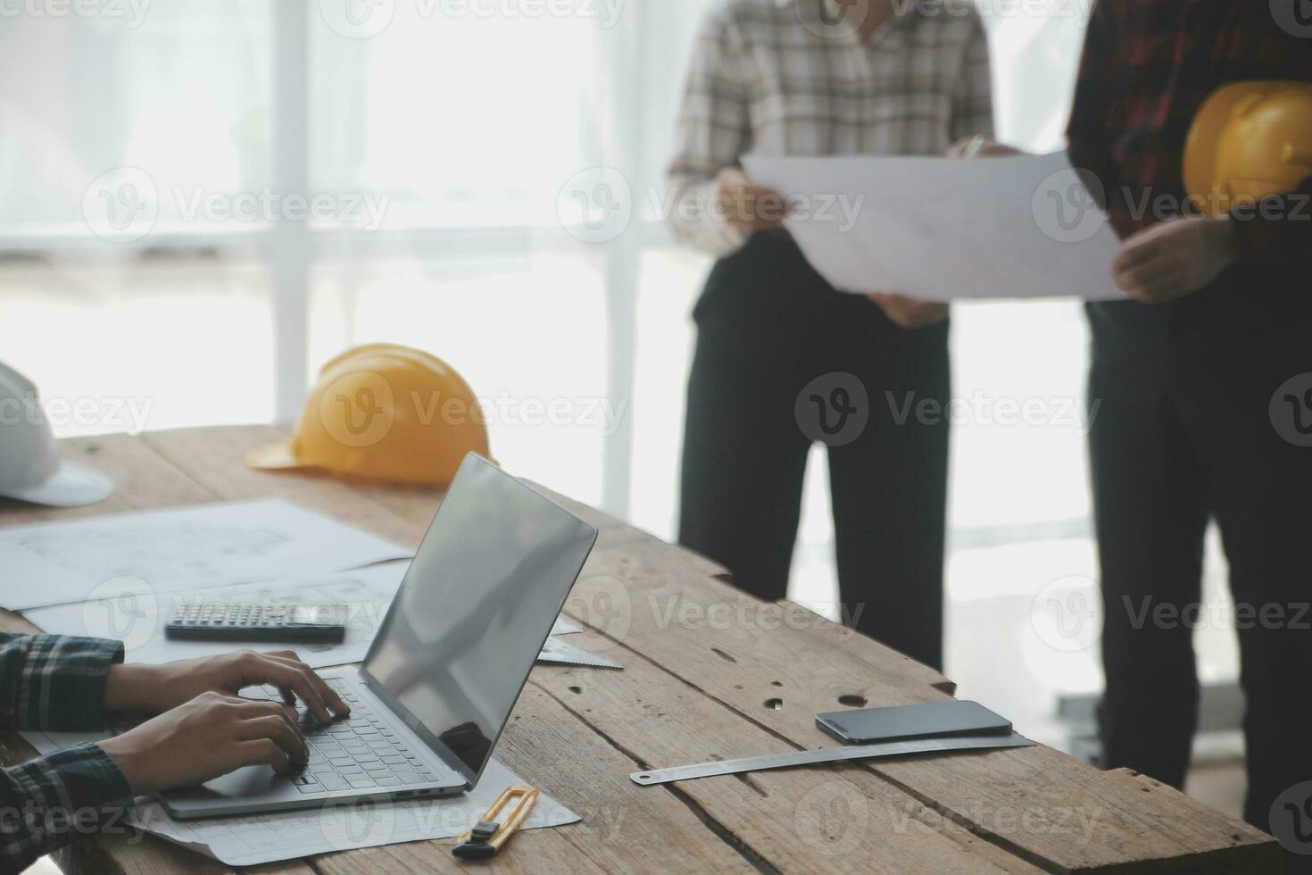 Construction and structure concept of engineer working drawing on blueprint meeting for project working with partner on model building and engineering tools in working site, construction concept. photo