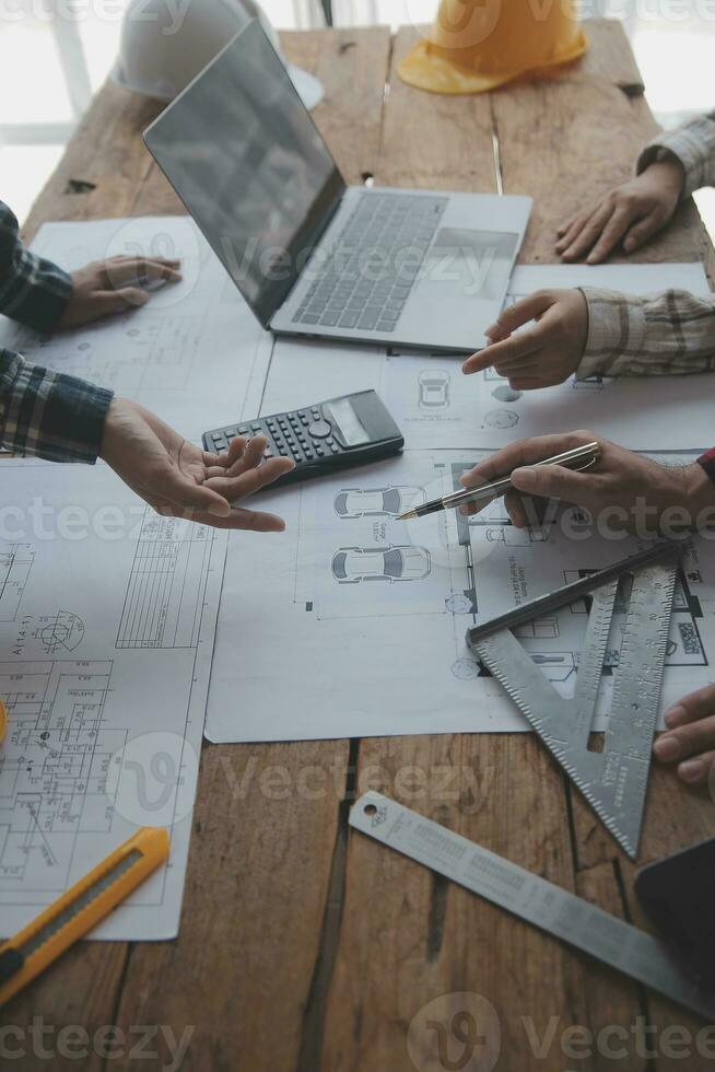 Construction and structure concept of engineer working drawing on blueprint meeting for project working with partner on model building and engineering tools in working site, construction concept. photo