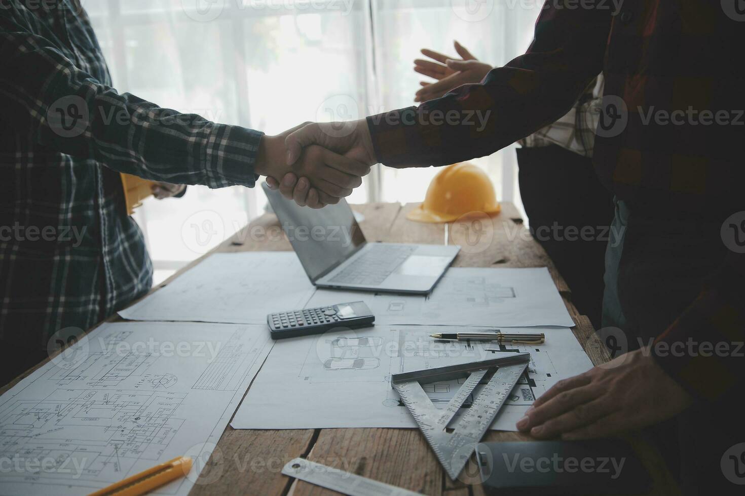 Construction and structure concept of engineer working drawing on blueprint meeting for project working with partner on model building and engineering tools in working site, construction concept. photo
