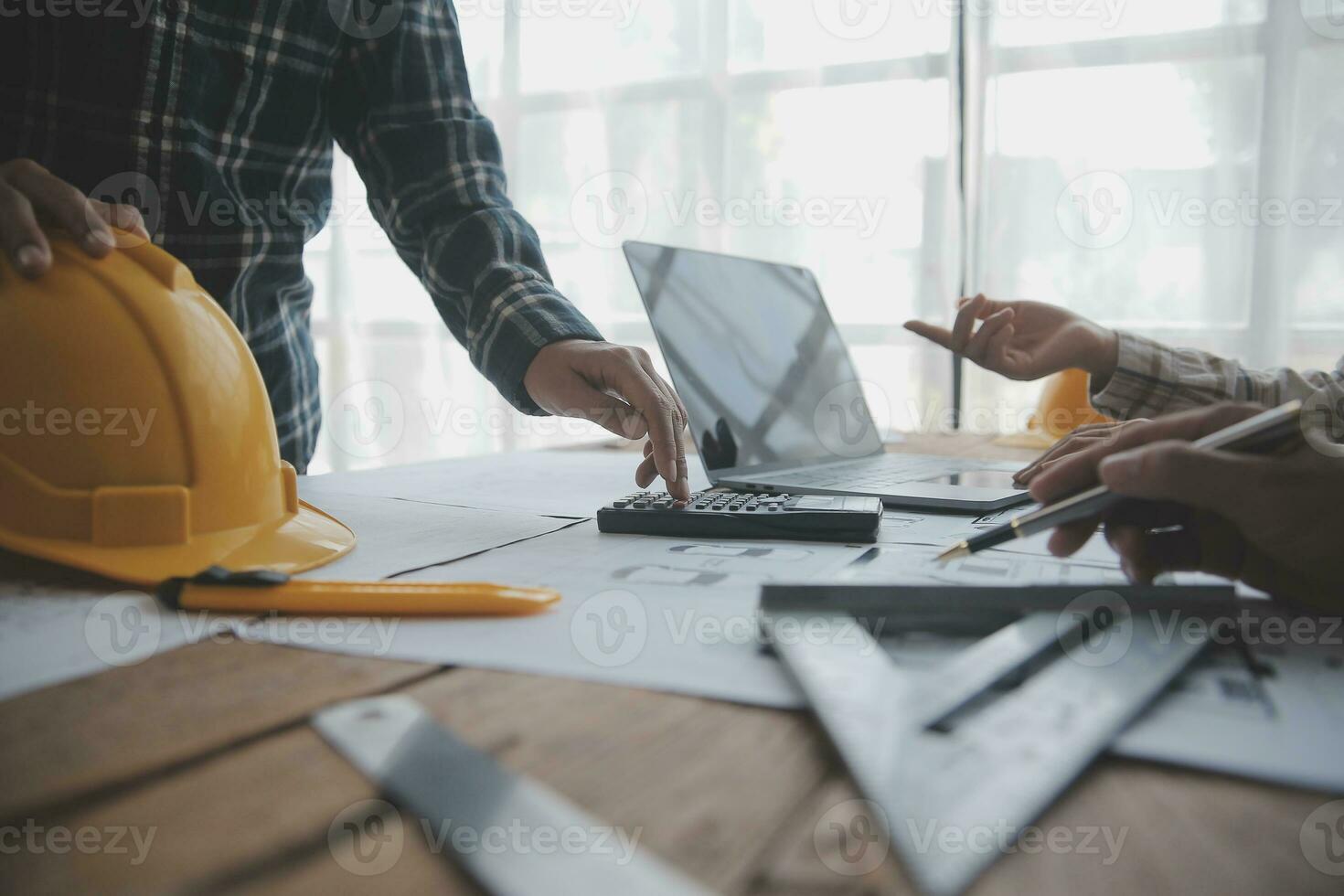 Construction and structure concept of engineer working drawing on blueprint meeting for project working with partner on model building and engineering tools in working site, construction concept. photo
