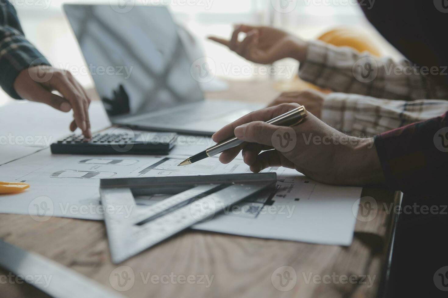 Construction and structure concept of engineer working drawing on blueprint meeting for project working with partner on model building and engineering tools in working site, construction concept. photo