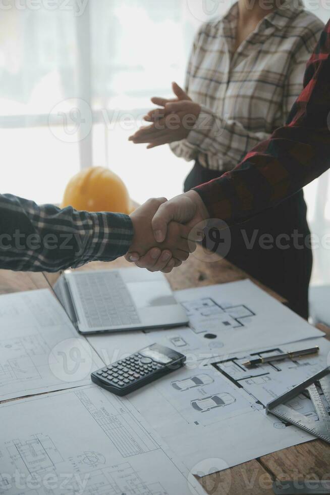 Construction and structure concept of engineer working drawing on blueprint meeting for project working with partner on model building and engineering tools in working site, construction concept. photo