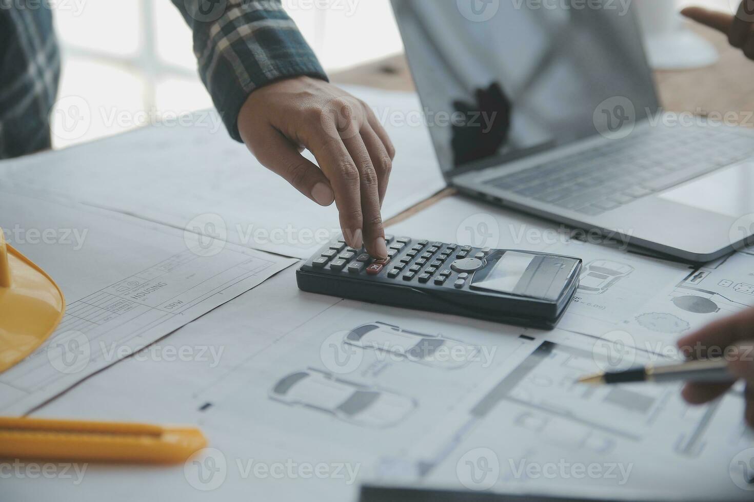Construction and structure concept of engineer working drawing on blueprint meeting for project working with partner on model building and engineering tools in working site, construction concept. photo