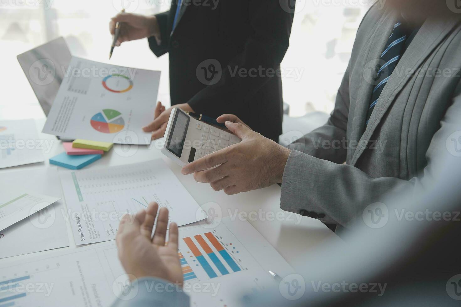 Financial analysts analyze business financial reports on a digital tablet planning investment project during a discussion at a meeting of corporate showing the results of their successful teamwork. photo
