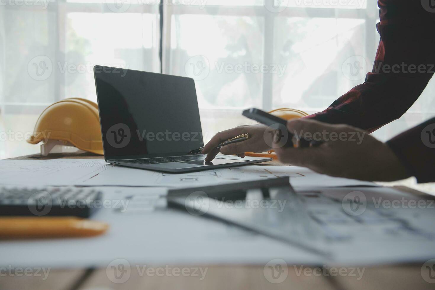 Construction and structure concept of engineer working drawing on blueprint meeting for project working with partner on model building and engineering tools in working site, construction concept. photo