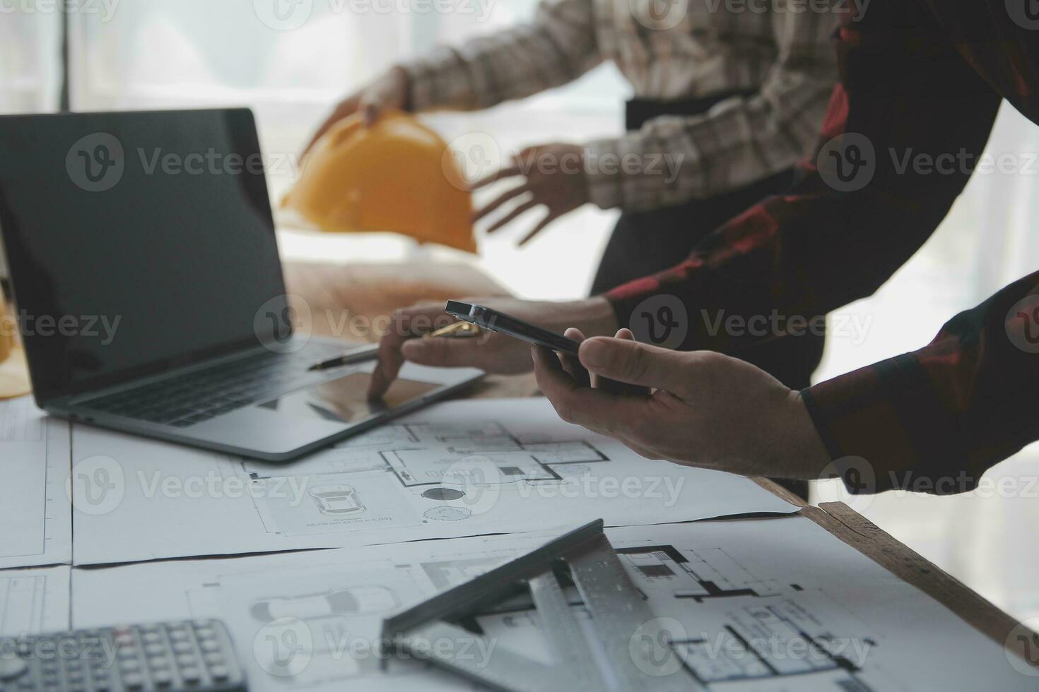 Construction and structure concept of engineer working drawing on blueprint meeting for project working with partner on model building and engineering tools in working site, construction concept. photo