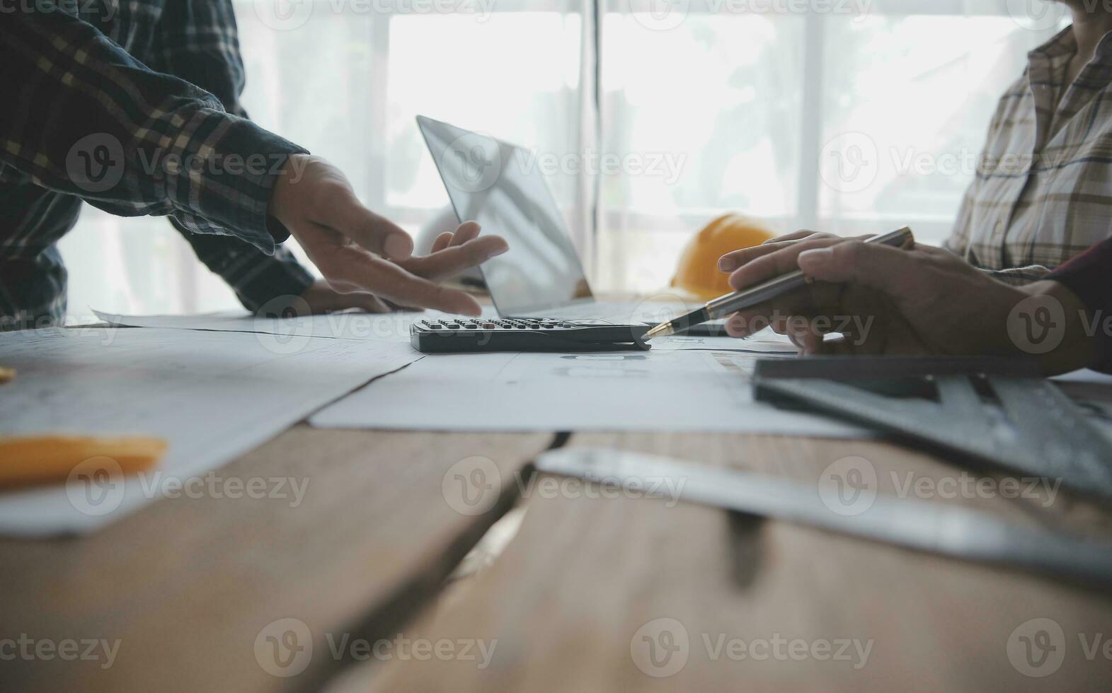 Construction and structure concept of engineer working drawing on blueprint meeting for project working with partner on model building and engineering tools in working site, construction concept. photo