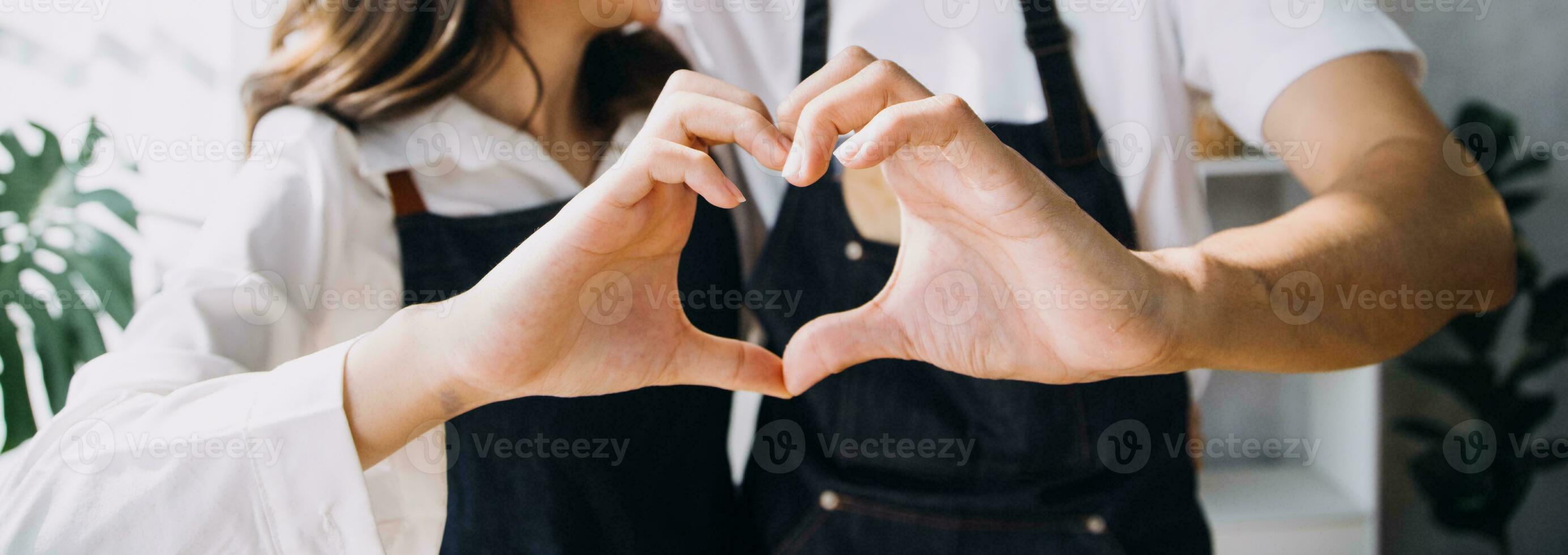 Happy young adult couple making breakfast and drinking coffee together in cozy home kitchen in morning at home. Preparing meal and smiling. Lifestyle, leisure and Love concept. photo